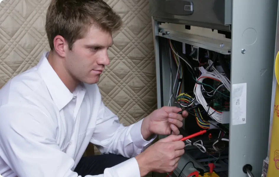 An HVAC Technician working on a unit