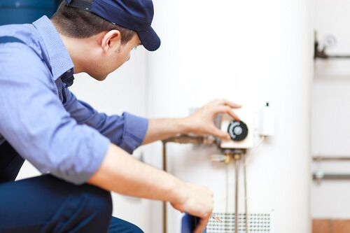 Image showing the installation of a water heater in a residential setting.