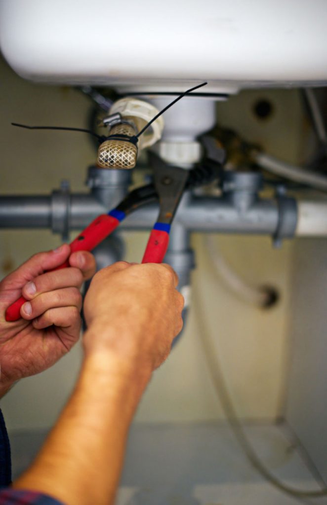 Stock photo of a typical kitchen plumbing setup showing a sink and fixtures.